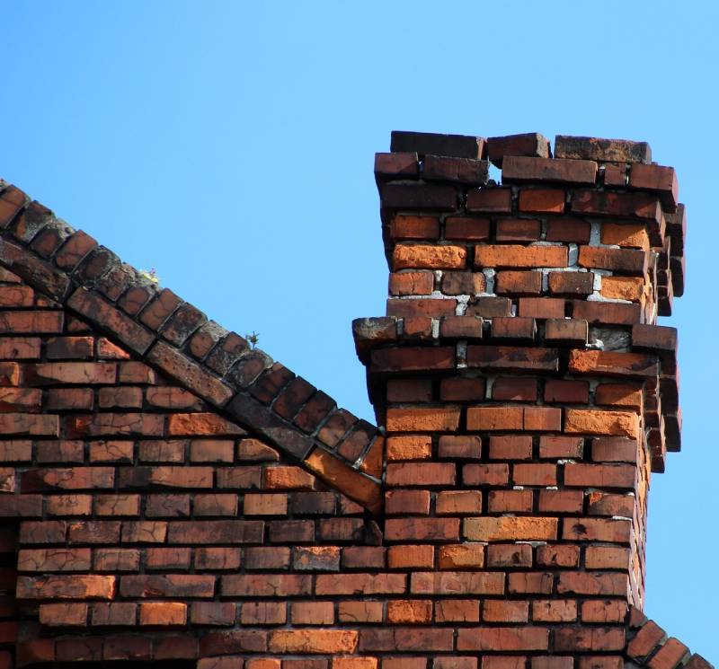 Signs Your Norwood Home Needs a Chimney Inspection Damaged chimney on an Norwood home showing cracks and missing mortar